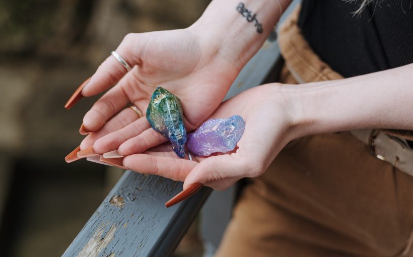 Crop woman showing opals in hands